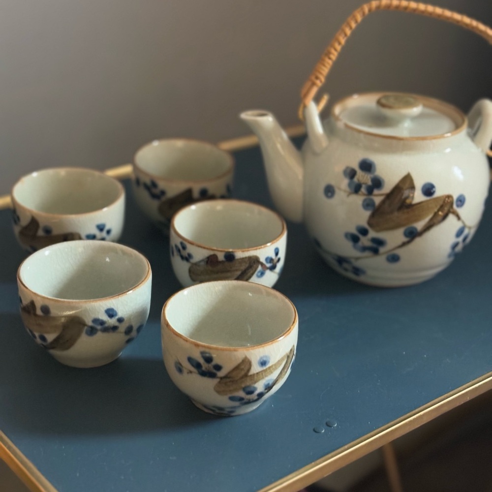 Japanese-style ceramic tea set with a cherry blossom design.